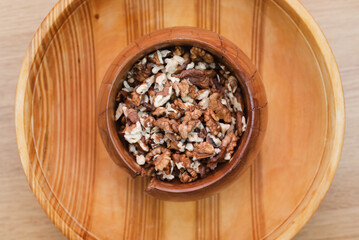 Walnuts are peeled in a wooden plate, necessary nuts for normal human mental activity, top view