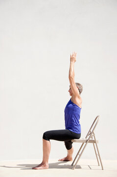 Middle aged senior yoga woman demonstrating asana for aging bodies. 