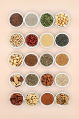 Healthy lipids unsaturated essential fatty acids. Food ingredients containing good fats for a healthy heart and low cholesterol levels with nuts, seeds, legumes and grain. On neutral background.