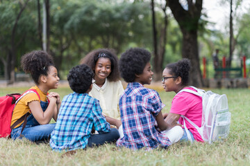 Group of African American children learning outdoor in the park. Diversity black people learning outside the classroom. Kids field trips outside. Kids and educational concept