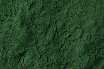 Heap of green spirulina powder close up full frame as background