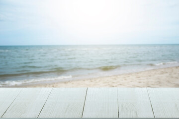 Beautiful wooden floor and blue background, sea water and sky.