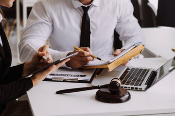 Male lawyer working with contract papers and wooden gavel on tabel in courtroom. justice and law ,attorney, court judge, concept.