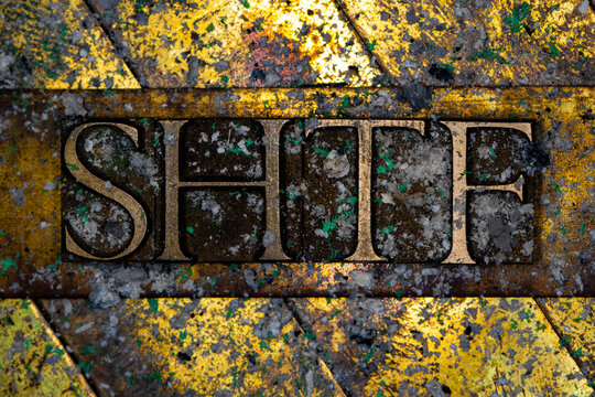 SHTF text with nuclear fallout on grunge textured copper and gold background