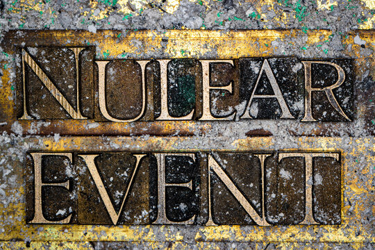Nuclear Event text with nuclear fallout on grunge textured copper and gold background