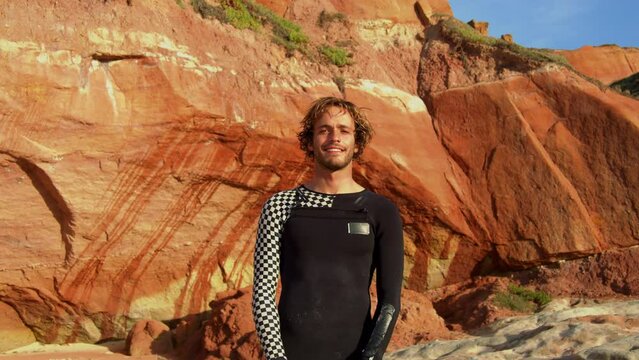 Surfer Guy Smiling And Doing Hawaiian Shaka Hand Sign For Fun After Surf Session