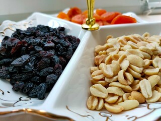Close-up of dried fruits and nuts. Dried fruits and nuts in a white bowl.