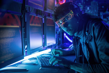 Fototapeta premium Caucasian young man playing game at home, colorful lights room, fun hobby concept