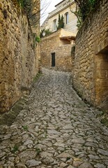 Stones and cobblestones alley in the historic Bordeaux village of St. Emillion, France.