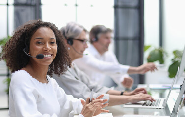 Fototapeta na wymiar african american operator smiling in a call center