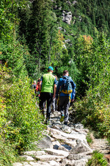 Fototapeta na wymiar Tourists walk along a mountain trail in the Tatras in Slovakia