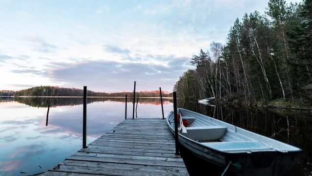 Time laps of clouds moving over lake in sunset 