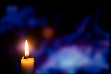 burning candle on bokeh background, blurred background
