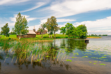 Fototapeta premium old wooden boat in a small picturesque bay on the lake