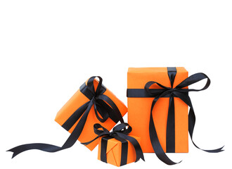 The Halloween gift box has an orange color with a black bow isolated on a transparent background.