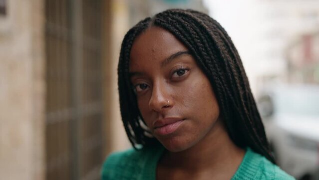 African american woman standing with relaxed expression at street