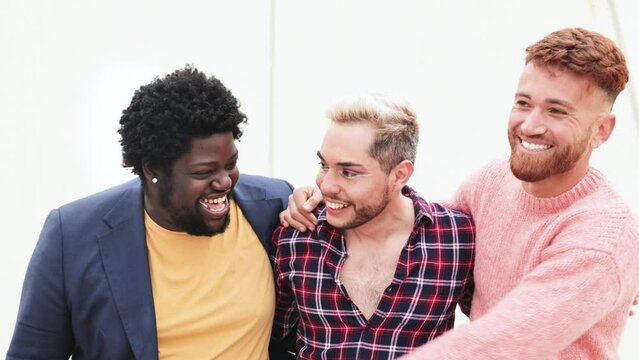 Happy group of diverse male friends having fun together outdoor - Multiethnic and lgbt community concept