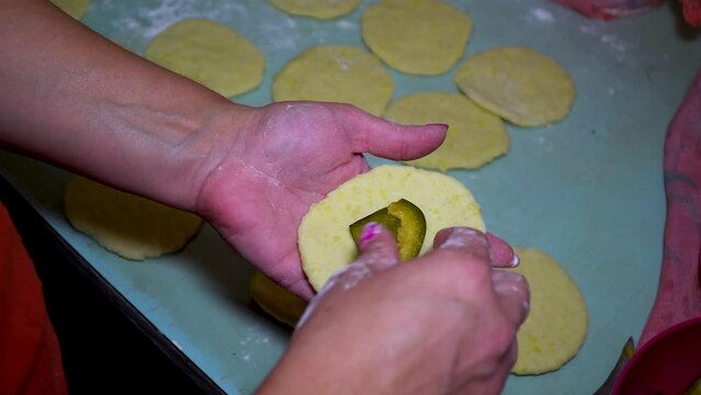 Sweet plum dumpling and a piece of yeast dough. Cooking plum dumplings. The process of making homemade apple and plum galette, hombovci 