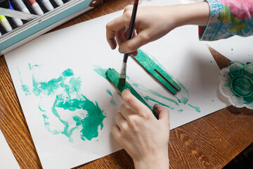 baby green paints wooden parts. creation