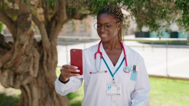 African american woman doctor smiling confident make selfie by smartphone at park
