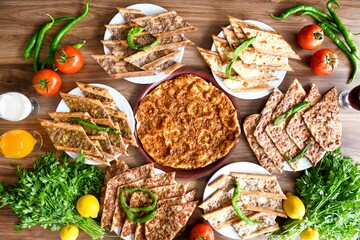 Delicious meat kebab with fresh vegetable salad served with variety of Turkish dishes and appetizers. Top view of assorted Turkish food and meze, tasty and healthy Mediterranean cuisine.