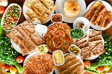 Traditional Turkish cuisine. Pizza, pita, pidesi, sucuk, hummus, kebab. Many dishes on the table. Serving dishes in restaurant. Background image. Top view, flat lay