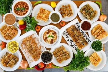 Delicious meat kebab with fresh vegetable salad served with variety of Turkish dishes and appetizers. Top view of assorted Turkish food and meze, tasty and healthy Mediterranean cuisine.