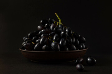 A bunch of grapes on a dark background.
