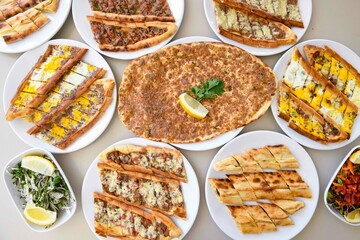 Delicious meat kebab with fresh vegetable salad served with variety of Turkish dishes and appetizers. Top view of assorted Turkish food and meze, tasty and healthy Mediterranean cuisine.