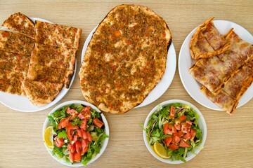 Delicious meat kebab with fresh vegetable salad served with variety of Turkish dishes and appetizers. Top view of assorted Turkish food and meze, tasty and healthy Mediterranean cuisine.