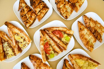 Delicious meat kebab with fresh vegetable salad served with variety of Turkish dishes and appetizers. Top view of assorted Turkish food and meze, tasty and healthy Mediterranean cuisine.