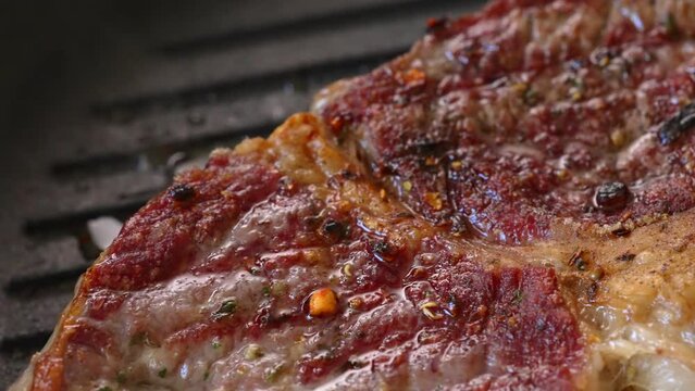 Beef entrecote is fried in a pan.