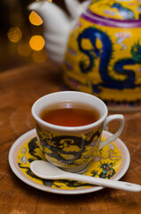 Darjeeling tea cup and traditional pot.