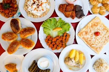 Delicious meat kebab with fresh vegetable salad served with variety of Turkish dishes and appetizers. Top view of assorted Turkish food and meze, tasty and healthy Mediterranean cuisine.