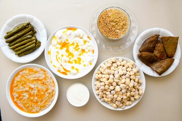 Delicious meat kebab with fresh vegetable salad served with variety of Turkish dishes and appetizers. Top view of assorted Turkish food and meze, tasty and healthy Mediterranean cuisine.