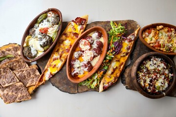 Delicious meat kebab with fresh vegetable salad served with variety of Turkish dishes and appetizers. Top view of assorted Turkish food and meze, tasty and healthy Mediterranean cuisine.