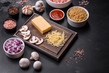 Raw pasta, mushrooms, onions, mince, spices and herbs to make a delicious paste