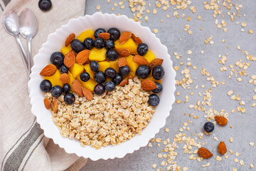 Bowl of oatmeal porridge with fresh fruits