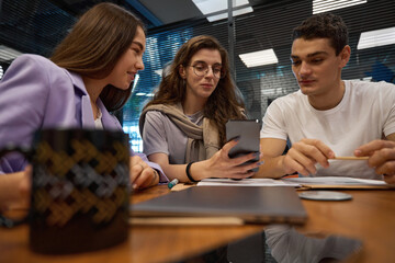 Colleagues looking at photos on the phone during a break
