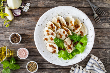 Dumplings - meat dumplings with onion and bacon on  wooden table
