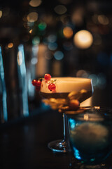 photo of a cocktail shown in a moody cocktail bar with bartender