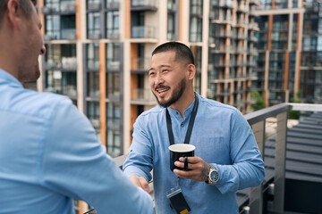 Fototapeta premium Asian businessman greeting his business partner with handshake