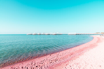 Summer beach with pink sand and turquoise sea. Toned image.