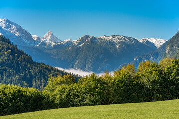 View to the Königssee covered with clouds. In the background the Steinerne Meer with the...