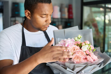 African american man holding a bouquet of flowers