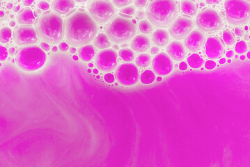 Soap foam. Background of dusty foam with bubbles of pink color for an inscription. Soap sud with copy-space