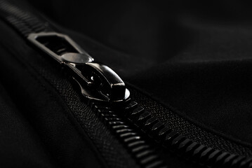 Black lock with a zipper on clothes close-up. Lock.