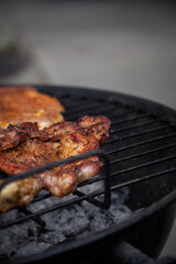 Pieces of crunchy meat freshly grilled on outdoor grill. 