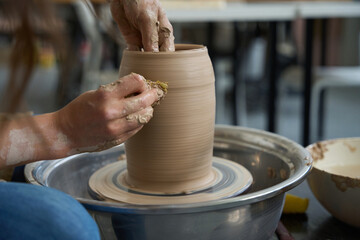 Fototapeta na wymiar Process of making a clay product on a potter wheel