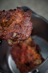 Pieces of crunchy meat freshly grilled on outdoor grill. 